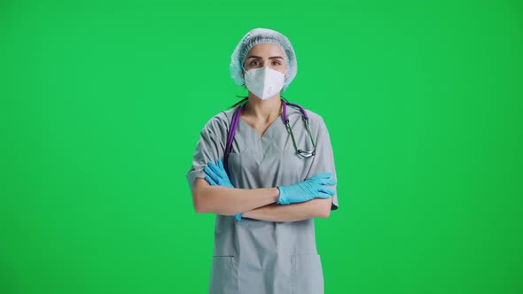 Portrait of Young Female Doctor in Protective Gear and Medical Mask Woman Looks at the Camera