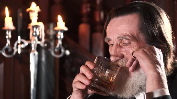 Senior Stylish Man Drinking Alcohol in Pub