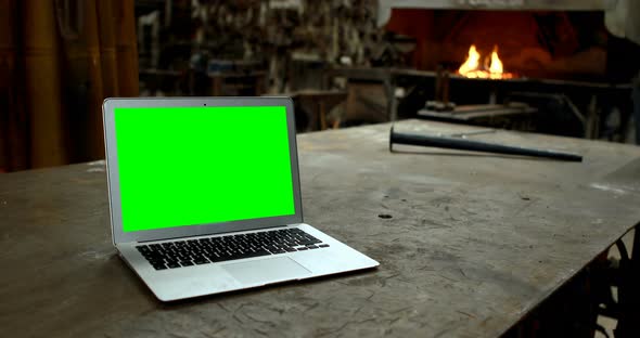 Laptop on a table in workshop 4k