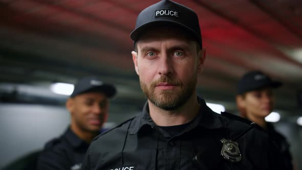 Police Man in Cap Posing at Camera