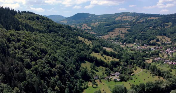 Rural Village At The Valley With Lush Green Forest Of The Mountain Range