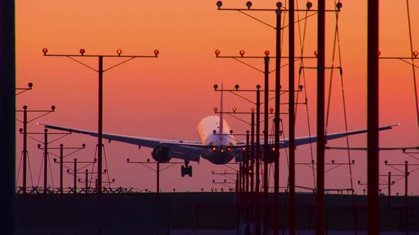 Jet Landing At Airport At Sunset