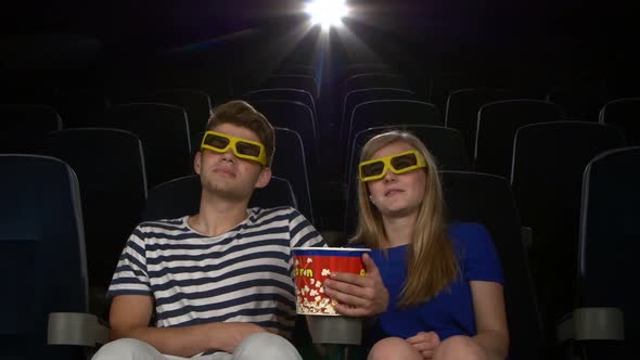 Great Movie! Young Couple Feeding Each Other at the Cinema. 3D Glasses