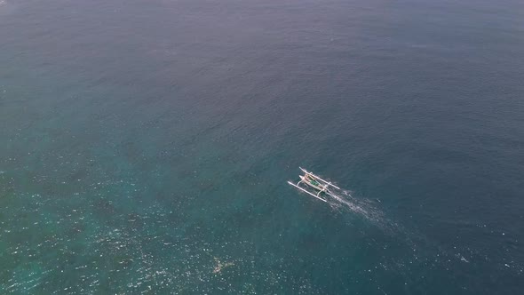 Aerial Drone Track View of a Tourist Boat Traveling Fast in the Serene Ocean