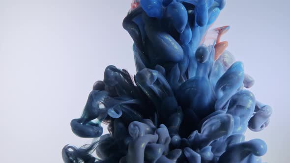 Colorful Nacreous Paint in Water Against White Background. alt