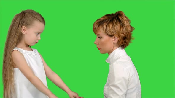 Mother Speaks with Her Daughter on a Green Screen, Chroma Key