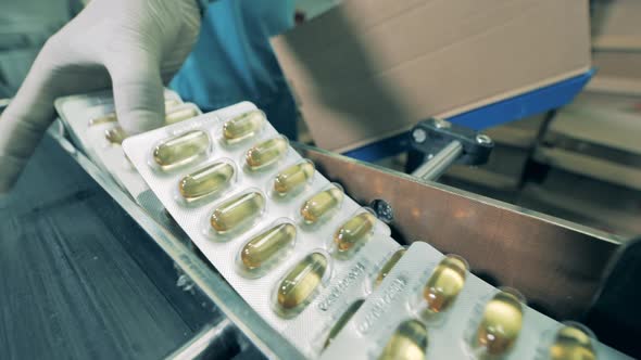 Pharmacologist Putting Blisters Packs in a Box. Close Up