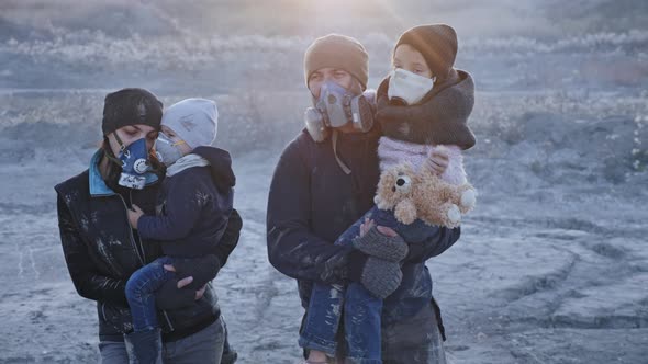 Survivor family in gas mask going through clouds of toxic smoke and cinder