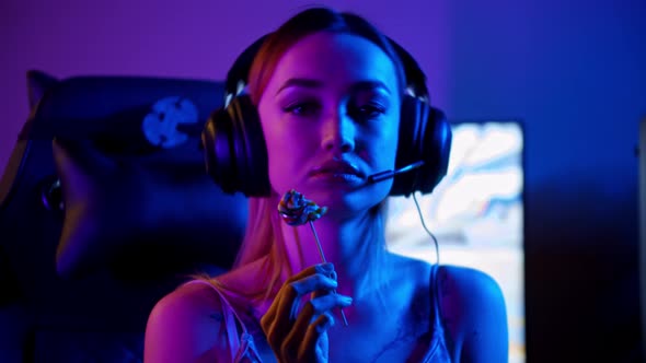 Tattooed Gamer Girl Sitting By the Gaming PC and Sucking a Lollipop