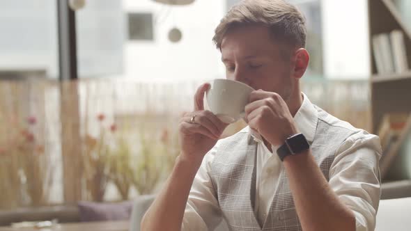 Businessman sitting and working in a cafe. Man using computer.