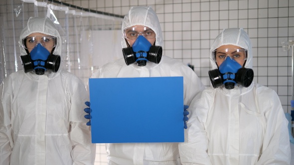 Lab Scientists in Safety Suits Holding Empty Board