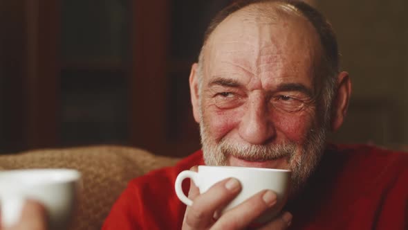 Happy Senior Man Enjoying Tea and Talking