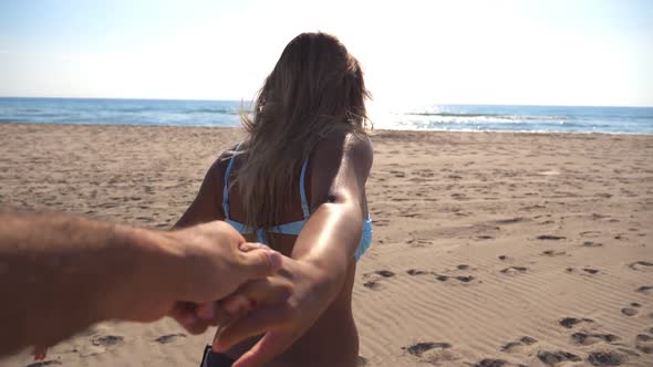 Follow Me Shot of Young Woman Pull Her Boyfriend to the Sea Shore on Sunny Day