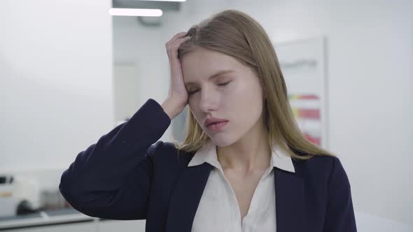 Portrait of Sad Tired Young Lady in Formal Clothes Looking in Camera