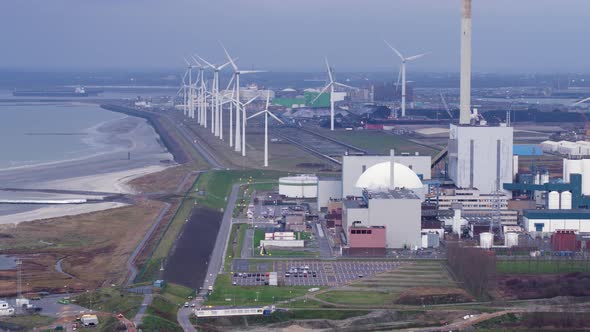 EPZ nuclear power plant facility with spinning wind turbines in background