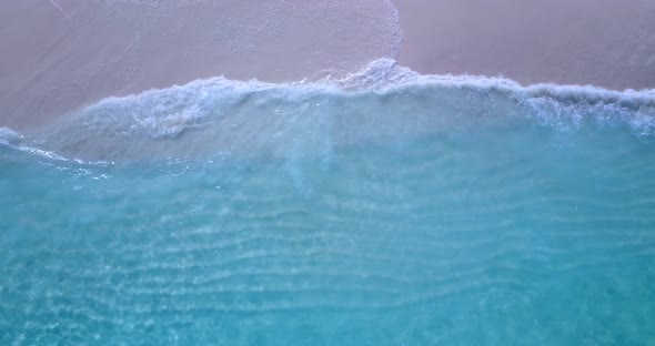 Luxury flying copy space shot of a white sandy paradise beach and blue water background in high reso