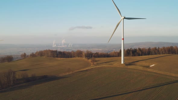 Wind Turbine Generate Electricity on the Background of Nuclear Power Station