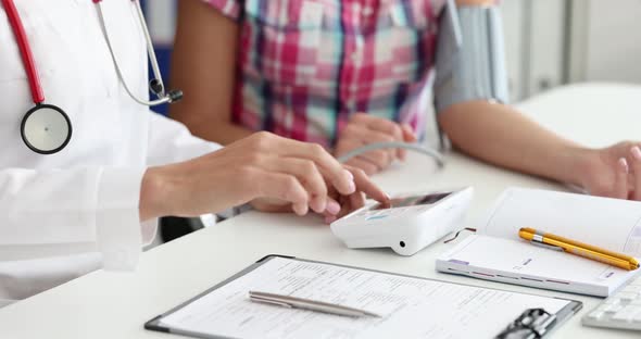 Doctor Measures the Patient Blood Pressure and Records Medical Parameters on Card  Movie