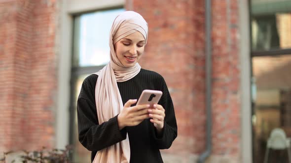 Happy Arabic Girl Sitting Outdoor Near Her Work Office and Checking Email on Digital Gadget