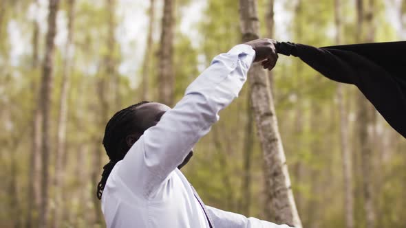 African Businessman Celebrating Success in the Nature While Spinning His Suit Around