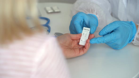 Doctors Hands Give Rapid Antigen Test for Covid19 and Pills to Patient in Clinic