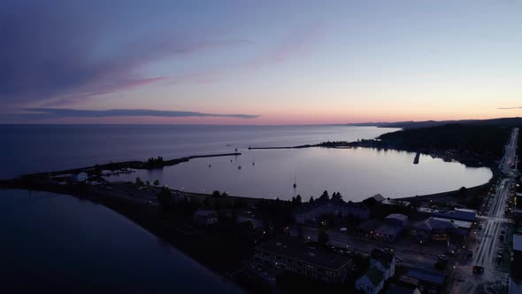 Aerial drone shot of a large boat harbor during a colorful sunset