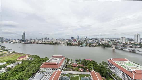 Timelapse movie over Chao Phraya river in Bangkok during sunset with cloudy skies