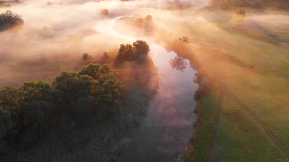 Aerial Drone View of Sunrise Over Misty River