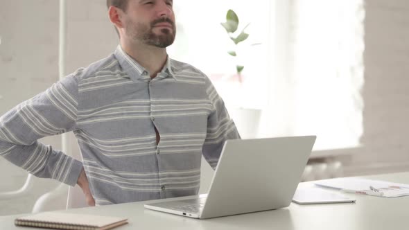 Adult Man with Back Pain Using Laptop