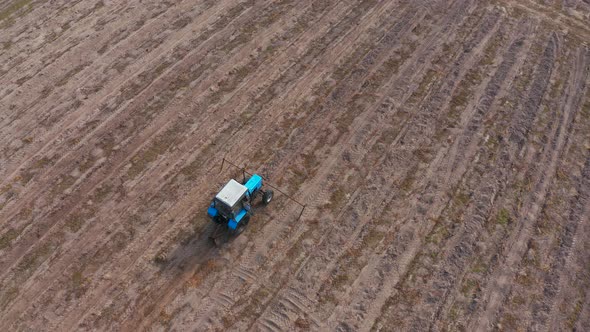 A Tractor Plowing a Field in the Fall. Preparing the Land for Winter. Spring Seeding. Aerial Footage