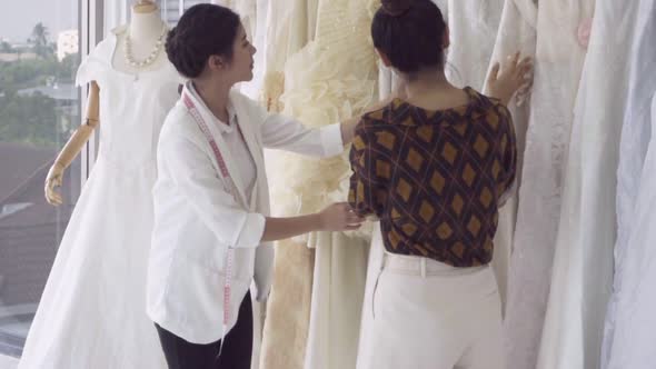 Future Bride Customer Talking with Wedding Store Shopkeeper