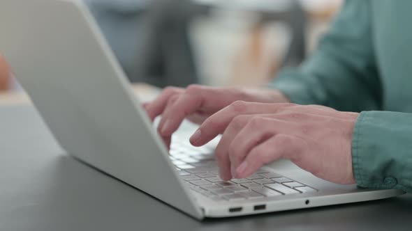 Close Up of Hands of Man Typing on Laptop