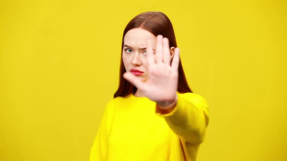 Annoyed Young Woman Stretching Hand To Camera in Slow Motion and Turning Aside