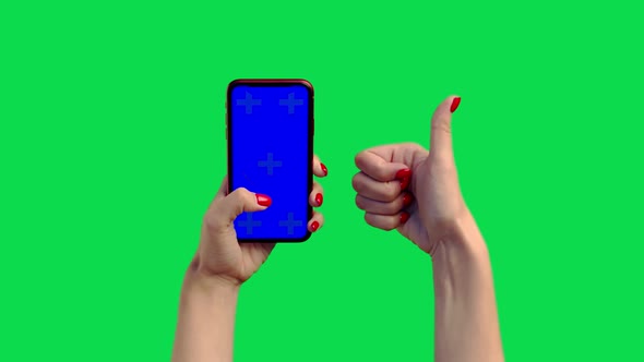 The Girl Holds a Phone with a Blue Screen on the Chromakey and Gives a Thumb Up. A Woman's Hand with