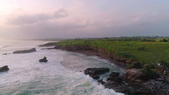 Flying Over A Beautiful Ocean Of Cliffs And A Beach With Black Volcanic Sand