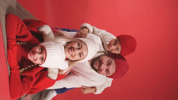 Portrait of Positive Caucasian Family in Studio, in Winter Clothes