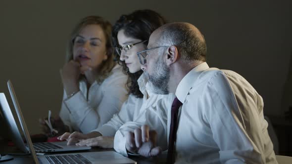 Business People Discussing Work in Dark Office