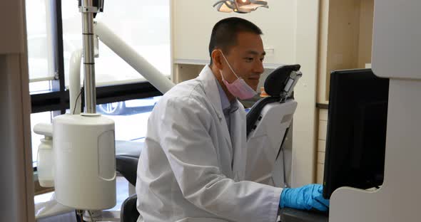 Male dentist using desktop pc 4k