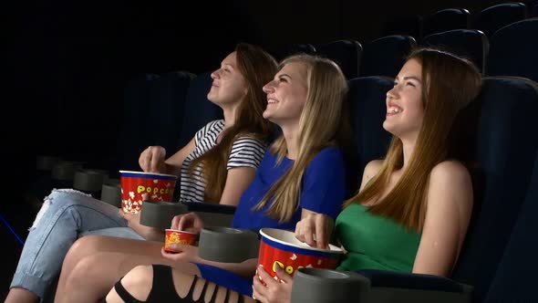 Girl Watching Саmedy Film at the Cinema, Eating Popcorn