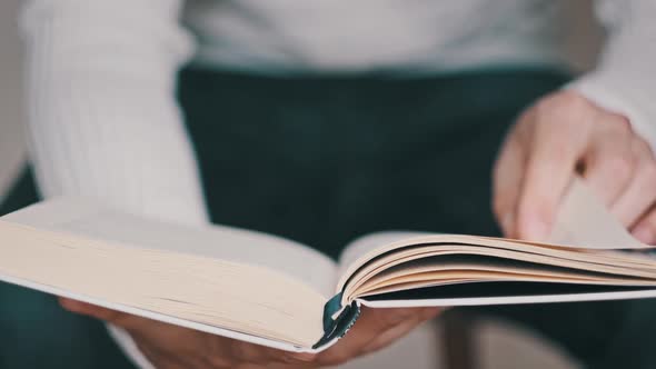 Reading a Book and Turning the Pages Close Up Slow Motion