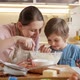 Happy Smiling Boy Kissing His Mother While Making Biscuit Dough at Home - VideoHive Item for Sale