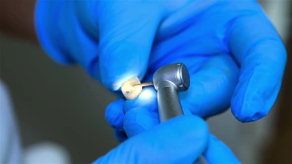 Dental Technician Polishing A Tooth