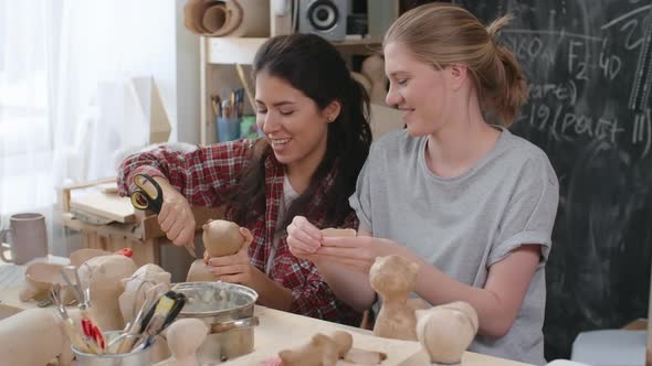 Woman Making Holes in Papier-Mache Toys