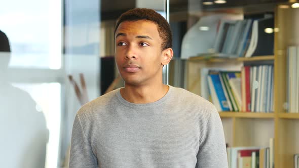 Young African Man Waiting and Watching Time on Watch