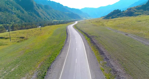 Flight Over Mountain Asphalt Highway Road and Meadow