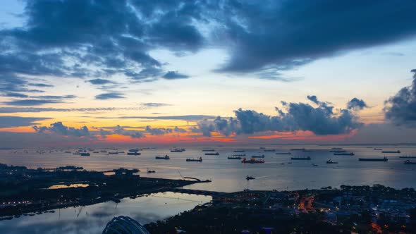 Time Lapse shot a beautiful sunrise and hundreds of cargo ships anchored off the coast of Singapore.