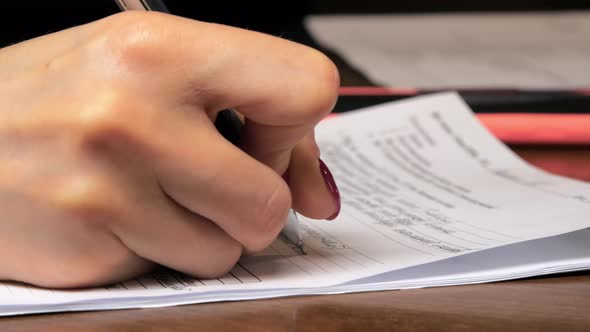 Careful Clerk Fills in Report Form on Paper with Pen
