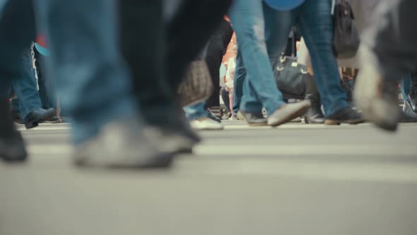 People Pedestrians Walks Across a Busy City Street