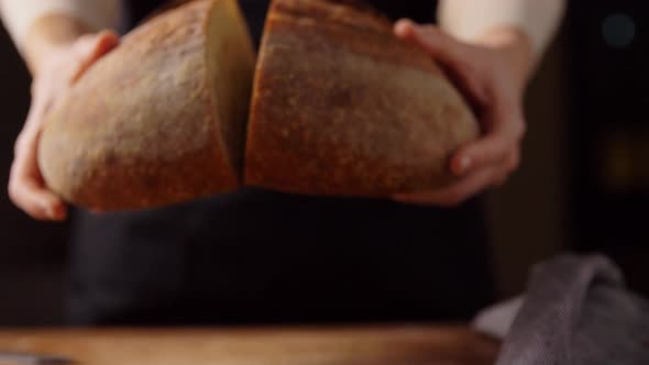 Female Baker Showing Homemade Bread at Bakery