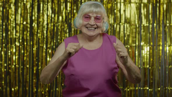 Senior Old Woman Dances, Listens Music on Headphones. Relaxing, Enjoying, Having Fun, Smiling